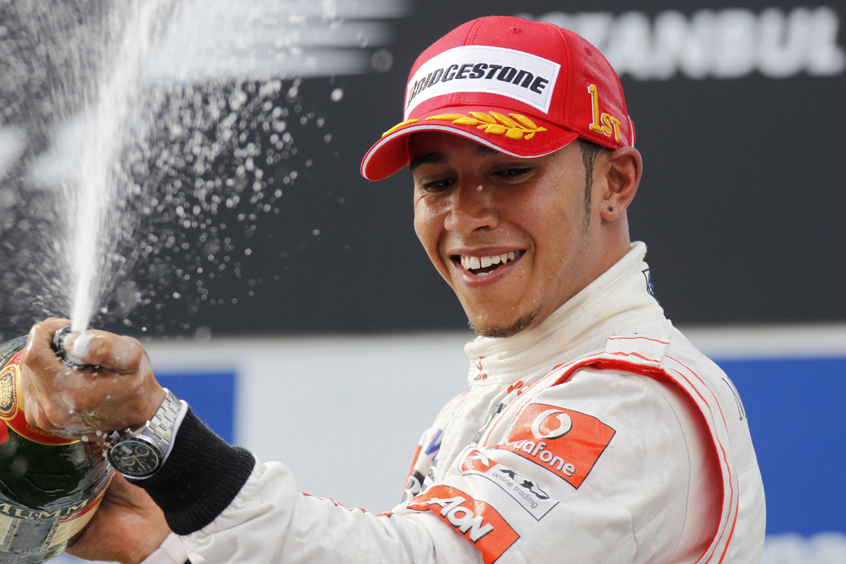 Formula One Race Car Driver Lewis Hamilton celebrating after winning at a Formula One event