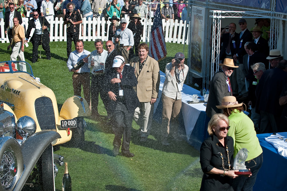 Amelia Island Concours d’Elegance founder Bill Warner being sprayed with champagne