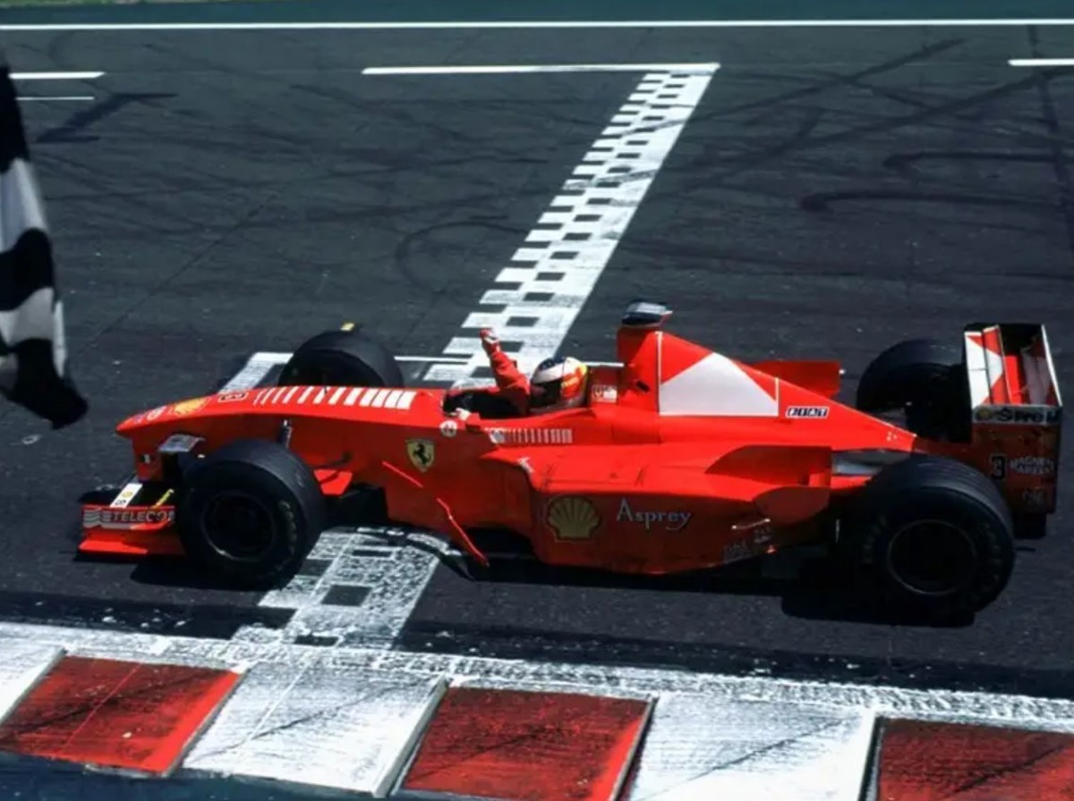 Michael Schumacher crossing the finish line in the 1998 Ferrari F300 offered at RM Sotheby’s Monterey live auction 2022